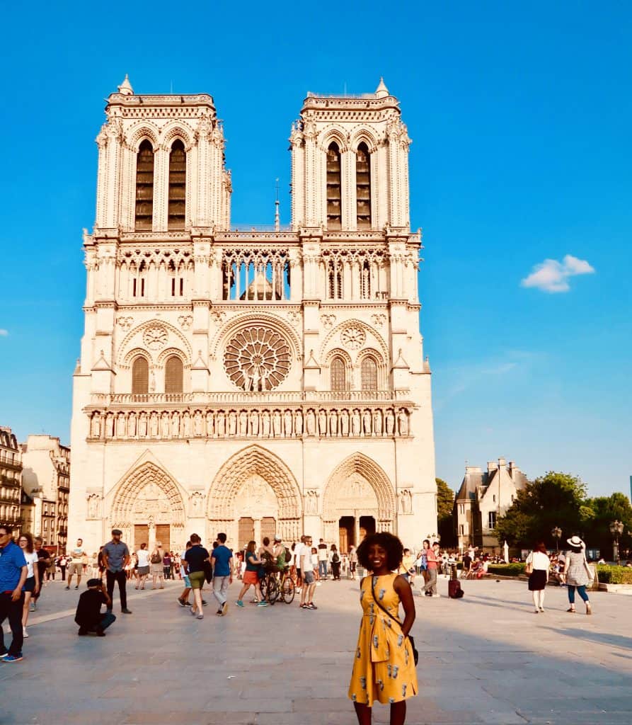 Woman stands outside Notre Dame