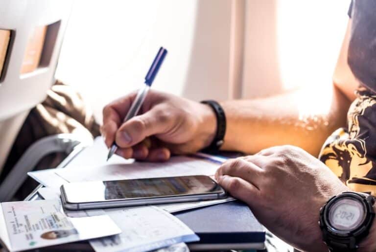 mobile passport vs. global entry; man filling out customs forms