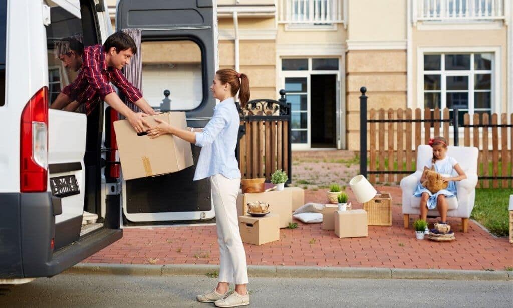 Man helping woman with moving boxes.