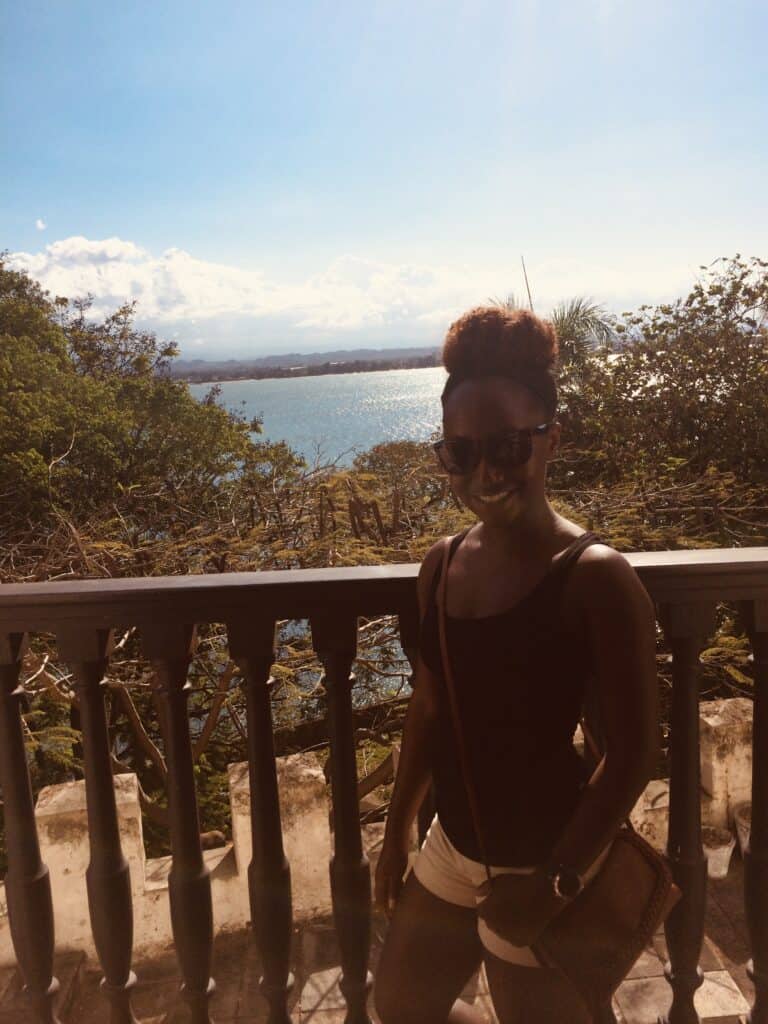 Woman on the Balcony of Casa Blanca in Old San Juan. Includes views of the water