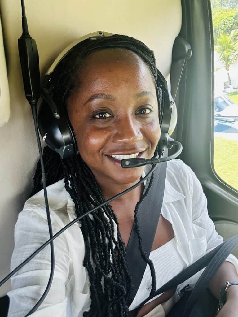 Black woman riding in helicopter