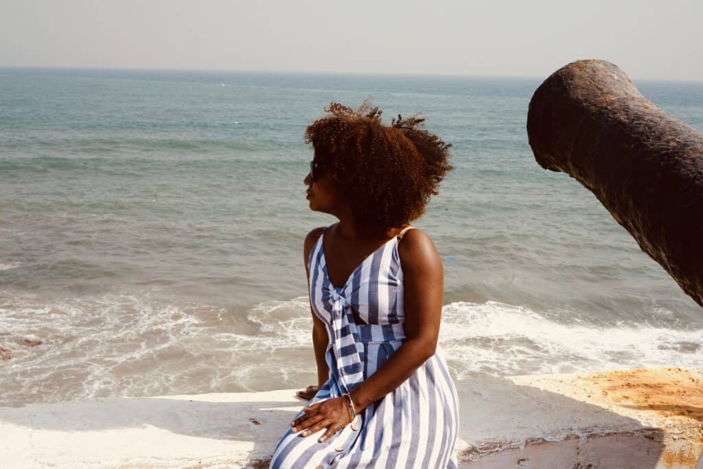 Black woman at Cape Coast Castle; historical sites in Ghana